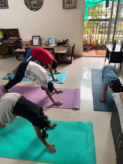 A duplicate of image 285, showing a group of kids in Downward-Facing Dog, a staple of our yoga practice.