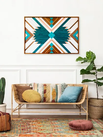 The Aztec-inspired art hung in a boho-chic living room. Its vibrant colors and bold pattern make it the perfect statement piece to tie the room together.