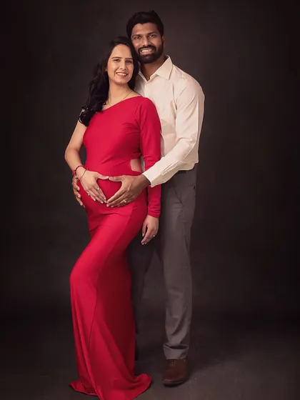 A full-length portrait showing the couple standing together, united and ready for their new chapter. The heart shape their hands make is a sweet detail.