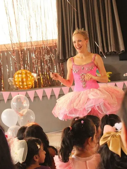 Our teacher, dressed as the Sugar Plum Fairy, leads the students in a dance. Our faculty loves to get into the spirit of our community events.