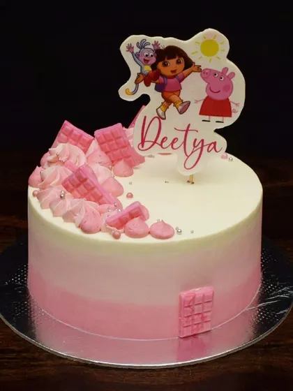 When a six-year-old can't decide between Dora the Explorer and Peppa Pig, you create a fun mashup. This pink ombre cake features a custom topper with both characters, ready for an adventure.