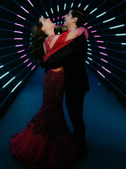 Love should be a celebration. We capture the energy and excitement of your journey, using creative lighting and dynamic settings to photograph the fun, modern side of your story, like this couple's embrace in a tunnel of light.