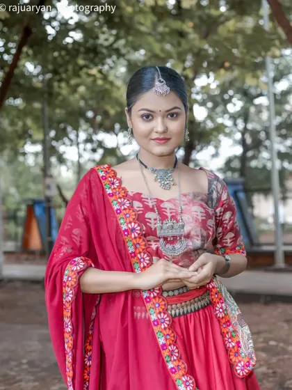A close-up portrait focusing on the model's serene expression and the details of her embroidered dupatta and silver necklace. The soft background keeps the attention on her.