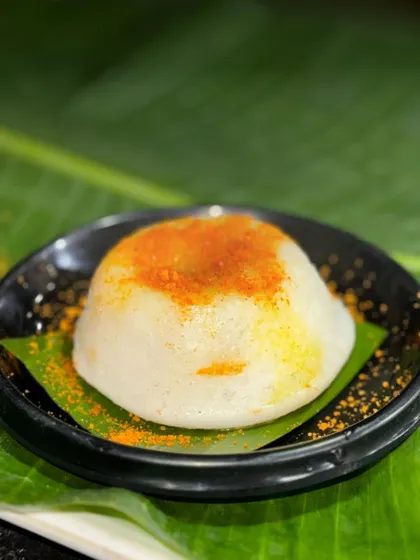 This is my Lava Idli, a dish with a delicious secret. When you cut into this fluffy idli, a stream of hot, flavorful sambar flows out, creating an interactive and satisfying experience.