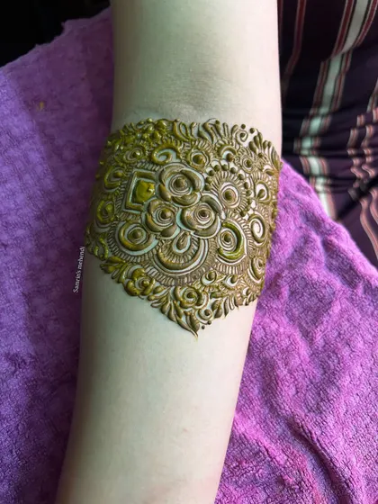 A close-up of the armband, featuring a beautiful and intricate 3D-style floral motif.