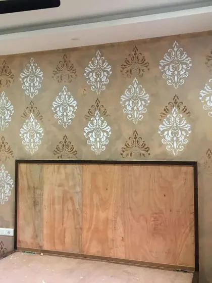 Another angle of the damask-stenciled bedroom wall, showing how the pattern wraps around the space. This technique is perfect for creating a feature wall behind a bed or in a formal living area.
