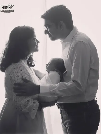 A new family of three. This classic black and white silhouette style portrait is timeless, focusing on the connection between the new parents and their precious baby.