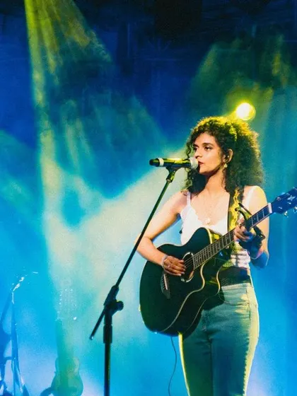 A professional shot capturing the beautiful blue and yellow stage lighting. The right lighting can completely transform a live music performance.