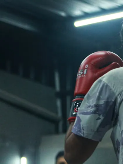 A close up of two fighters during a drill. The intensity is captured in their focused expressions.
