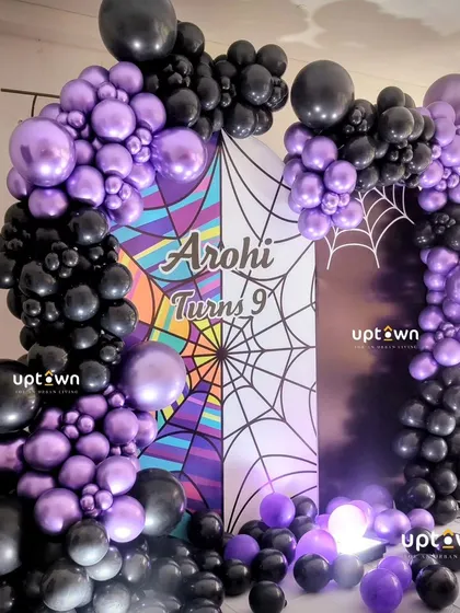 The rich chrome purple and black balloon's create a dramatic and stylish look for this unique birthday theme.