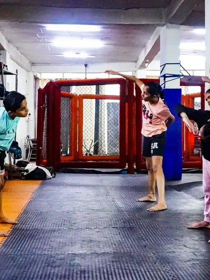 Kids practicing their fighting stance and warm-up drills. Our classes are structured to be engaging and teach fundamental movements correctly.