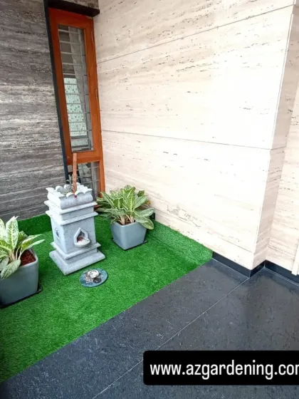 A wider view of the balcony corner, showing how the artificial grass patch defines the space and separates it from the main flooring.