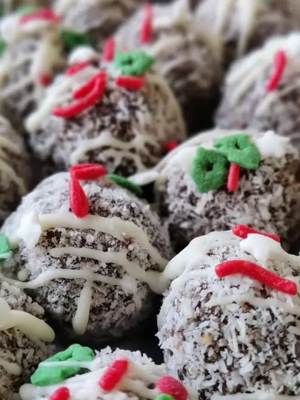 These Christmas rum balls are a bite-sized festive delight. They are made from our rich plum cake, rolled in coconut, and decorated with festive sprinkles.