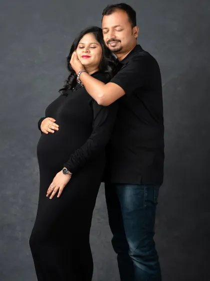 A gentle touch and a look of pure love. This dark, moody studio portrait is perfect for capturing the intimate and emotional side of pregnancy.