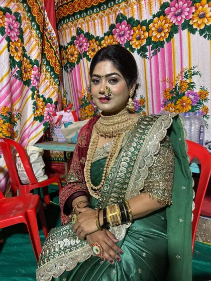 A front view of the beautiful bride in a green designer Nauvari. The traditional nath and jewellery add to the authentic Maharashtrian look.