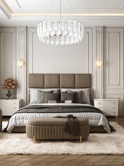 A serene and luxurious bedroom in neutral tones. The plush, oversized rug, tufted headboard, and crystal chandelier add layers of texture and sophistication, creating an inviting and comfortable retreat.