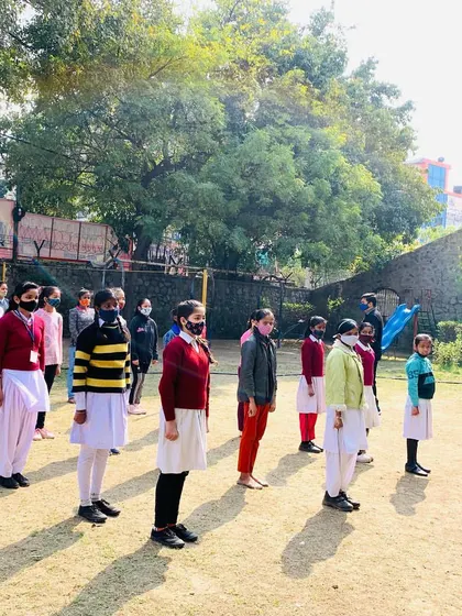Students at Day Time Secondary School stand in formation, ready and attentive for the next instruction. This posture itself is a sign of newfound discipline and confidence.