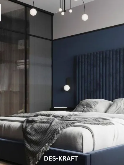 A glass-paneled wardrobe adds a touch of industrial chic and allows for an organized display, contrasting beautifully with the soft textures of the bed.