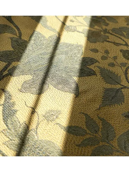 The 'Shagufta' fabric features delicate floral patterns on a muted, textured background. The play of sunlight on the weave highlights its sublime and subtle beauty.