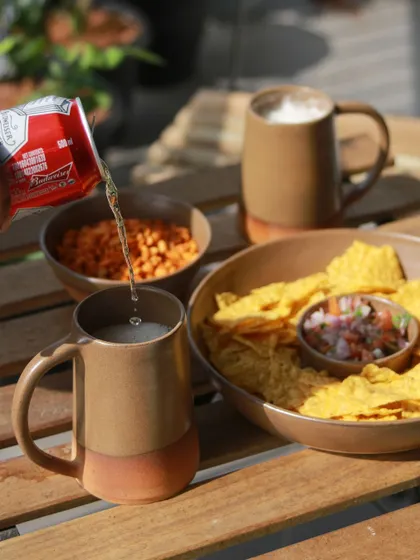 A student's barware collection, 'Moments Together,' inspired by cherishing gatherings with loved ones. This image shows beer mugs and snacks, creating a warm, inviting scene.