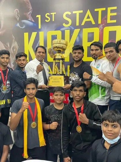 The team celebrating a huge win at the 1st State Level Kickboxing event. We came, we fought, and we conquered, taking home the championship trophy.