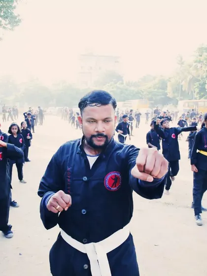 Leading from the front, I demonstrate a punching drill with my students. They mirror my movements, learning directly through observation and practice.
