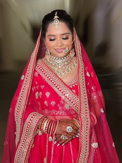 A moment of quiet contemplation for Divya. Her glittery eye makeup catches the light beautifully, adding a touch of glamour to her traditional look.