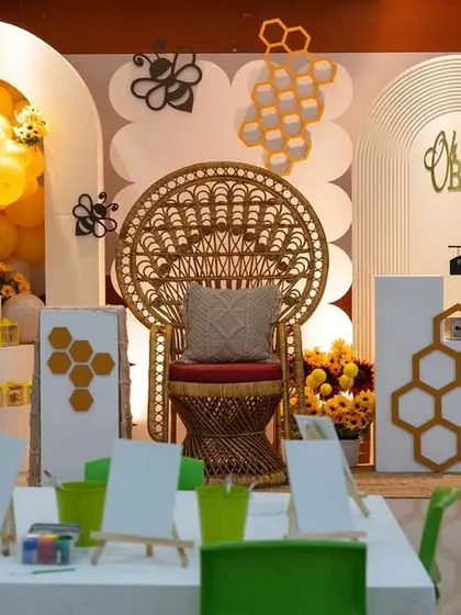 A wide view of the "Mom To Bee" baby shower, complete with a painting station for guests. I love incorporating interactive elements that make the celebration more memorable.