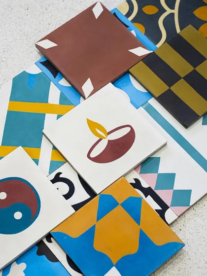 A fascinating collection of our 'Crimps' handmade cement tiles, featuring various custom designs and patterns, from a simple diya to a yin-yang symbol.