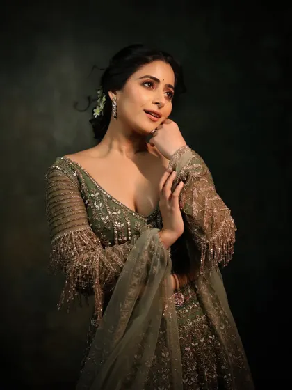 Draped in a beautiful green lehenga, this look is perfect for celebrating. The makeup is elegant and understated, allowing the outfit and the model's natural beauty to shine.