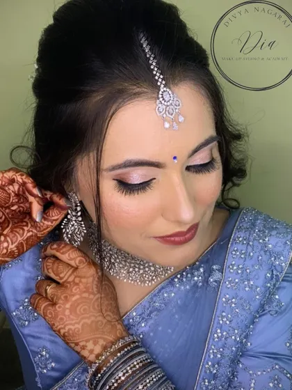 A close-up of the reception makeup, showing the soft pink shimmer on the eyelids and the flawless base. The diamond jewellery adds a touch of sparkle, completing this sophisticated and stylish look.