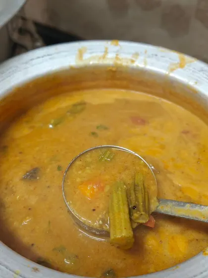 Our homemade sambar, full of vegetables and aromatic spices. It's the perfect accompaniment to idli, vada, or pongal and a staple in our South Indian catering menu.