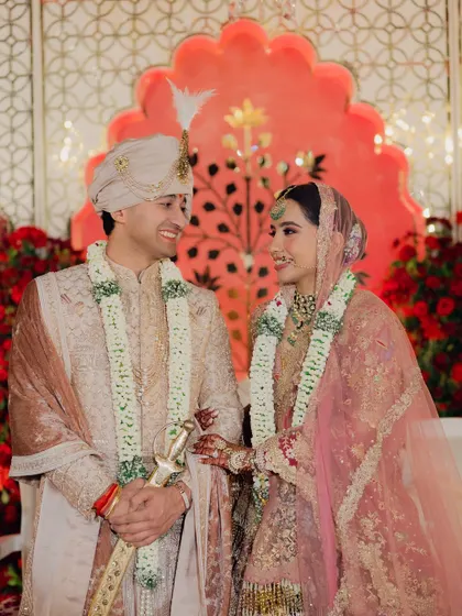 A beautiful candid moment between the bride and groom on their wedding stage. Their shared smile and loving gaze capture the happiness of their union.