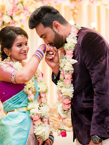A tender moment between the groom and bride during their engagement. The groom kissing her hand is a gesture of pure romance.