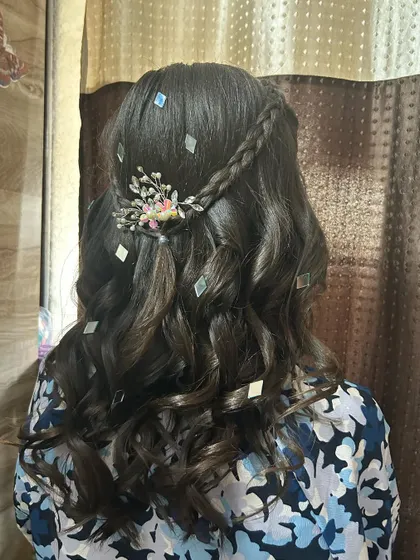 A beautiful half-up hairstyle with braids and curls for a cocktail party. The scattered diamond accessories add a touch of sparkle.