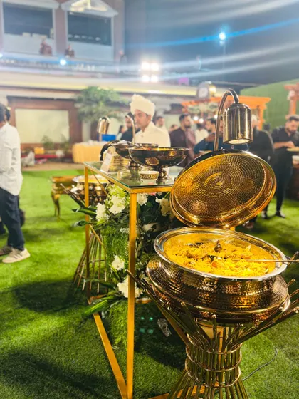 A close-up of the aromatic Mutton Mandi, a flavorful rice and meat dish, presented in a hammered brass pot.