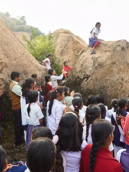 A group of schoolgirls gathers to watch their friend climb. It was amazing to see them go from shy and unsure to cheering each other on.