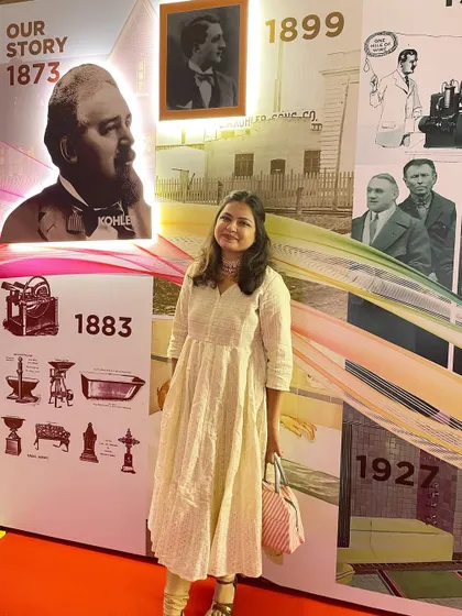 Posing with the history wall at the Kohler event. It was fascinating to immerse myself in their 150-year story before bringing it to life with sand.