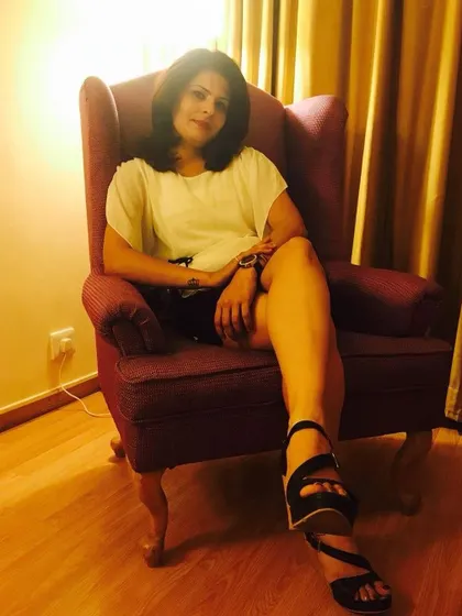 A relaxed, seated pose in a simple white top and black shorts. This is an example of timeless, comfortable style from my archives.