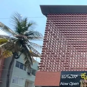 The exterior facade of Jagavi's Kritunga Restaurant in Mysore. This shot highlights the intricate, textured brickwork pattern that defines the building's unique character and street presence.