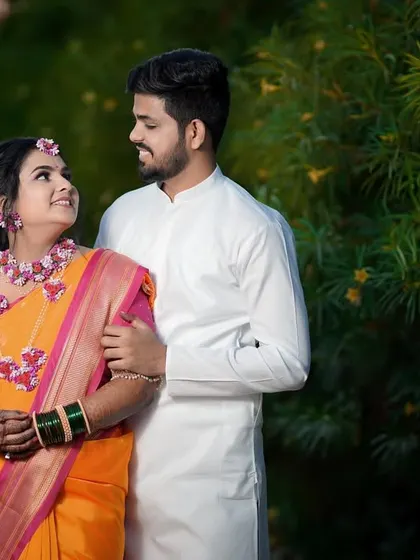 A sweet and simple portrait of a couple on their Haldi day. They share a look of love, dressed in traditional attire that complements the natural setting.