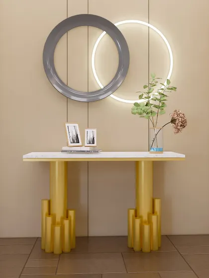 A playful and modern console table with sculptural yellow legs and a clean white top, accented by circular wall lights.