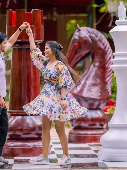 A playful dance on a giant chessboard. This unique prop adds a fun, whimsical element to the pre-wedding shoot.