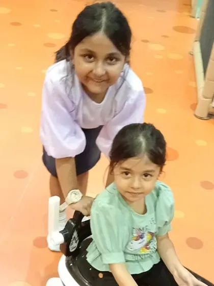 Giving a friend a ride around the play floor. Our open spaces are perfect for imaginative play with our selection of ride-on toys.