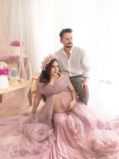 A dreamy, romantic portrait of a couple in our studio. The soft mauve gown, floral crown, and light-filled setup create an ethereal and gentle atmosphere, perfectly capturing their connection.