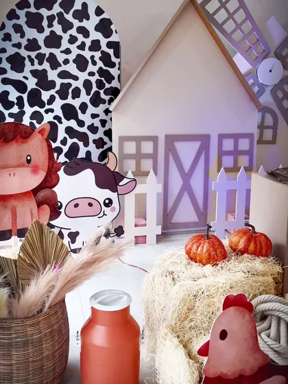 A farm theme aesthetic without balloons. This version uses hay bales, pumpkins, and animal cutouts to create a rustic and charming atmosphere.