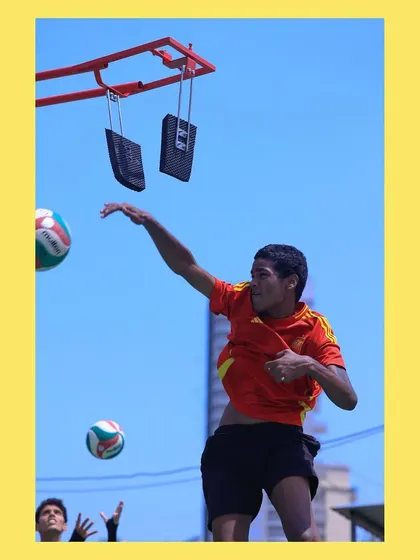 A player mid-swing, about to connect with the ball on the spike trainer. This drill isolates the hitting motion for maximum power.