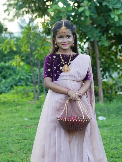 Another look at this stunning Langa Voni creation. The combination of the embroidered velvet blouse and the simple striped skirt creates a balanced and elegant outfit for any young girl.