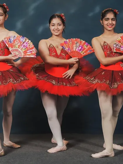 Dancers from our 'Don Quixote' performance. The use of fans as props adds a fiery, Spanish-inspired flair to the classic ballet choreography, showcasing both technique and personality.
