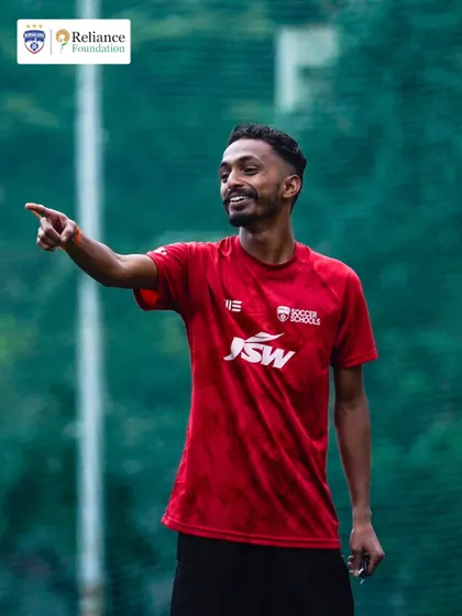 The joy of coaching is seeing our players grow. A coach smiles while guiding a session, reflecting the positive and encouraging atmosphere we cultivate at all our centers.